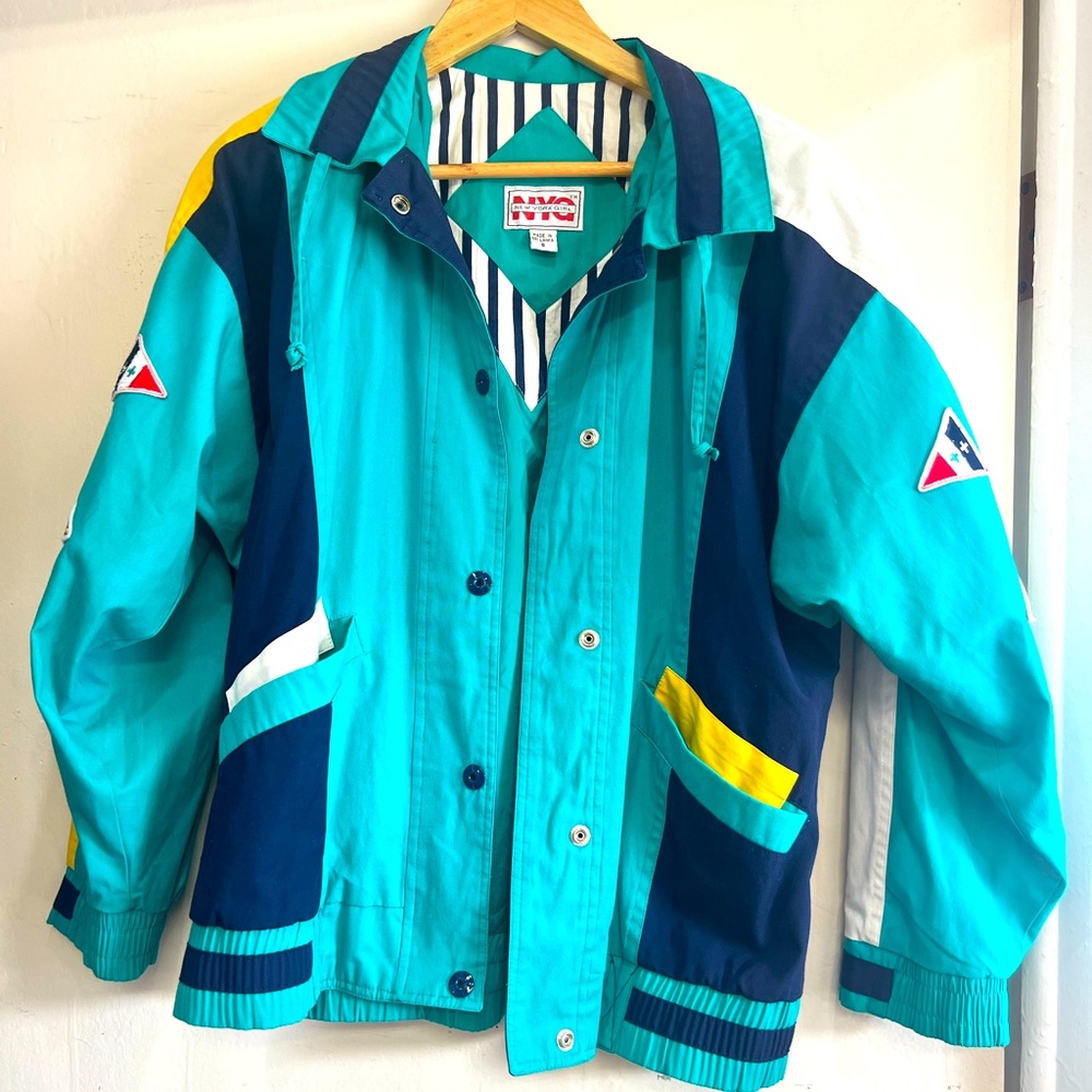 Amazing 80s color block jacket with flag patches! 
Size small